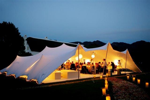 Stretch tent at wedding with pool in foreground