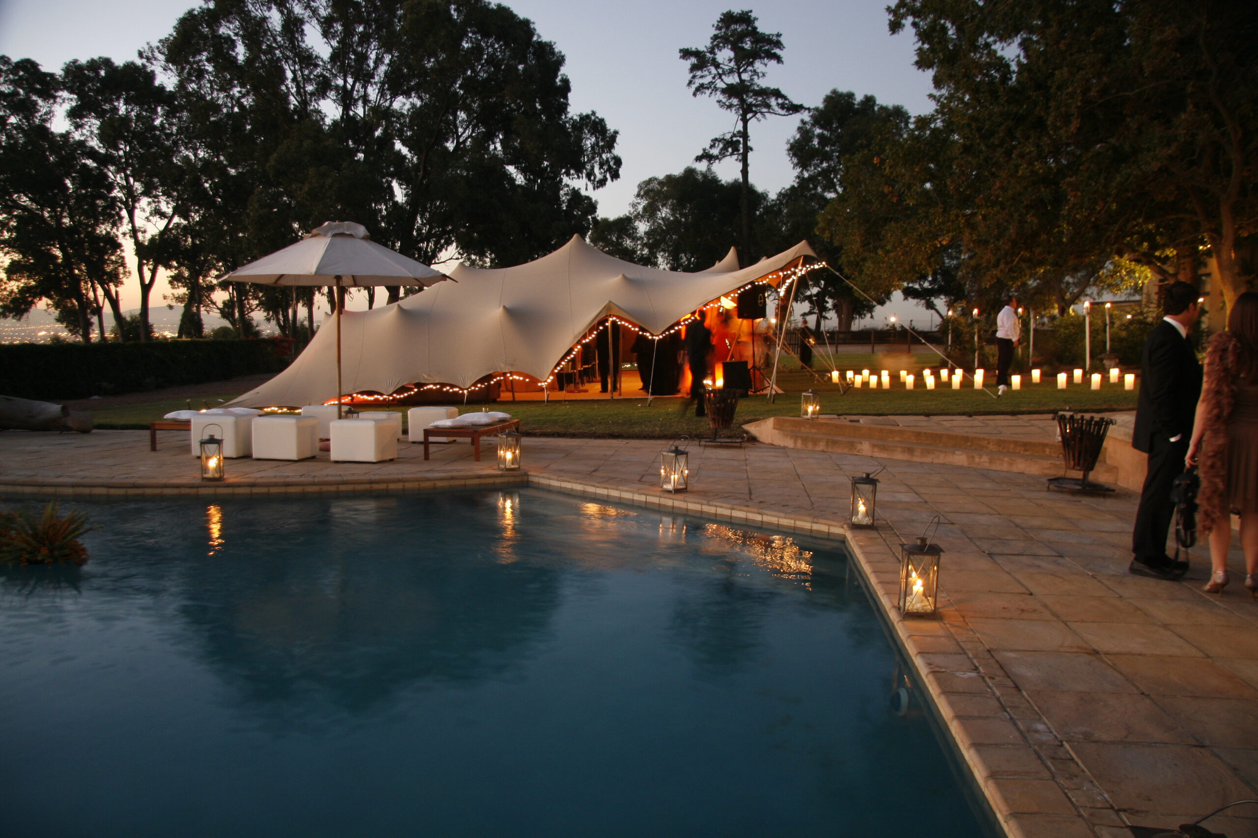 Stretch tent at wedding with pool in foreground